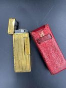 A Vintage Dunhill lighter in original red leather holder.