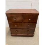 A mahogany chest of drawers on bun feet (H90cm W90cm D48cm)