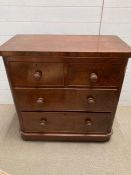 A mahogany chest of drawers on bun feet (H90cm W90cm D48cm)