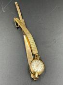 A 9ct gold Felca Ladies watch AF on a rolled gold strap.