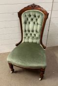 A button back slipper chair on turned legs and castors