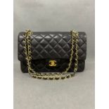 A Chanel Classic double flap 10 inch quilted lambskin leather, with gold hardware, woven chain