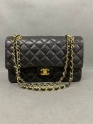 A Chanel Classic double flap 10 inch quilted lambskin leather, with gold hardware, woven chain