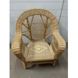 A wicker oversized cane chair