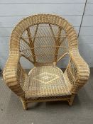 A wicker oversized cane chair