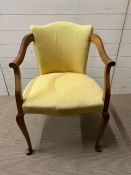 An Elm elbow chair with down swept arms and cabriole legs