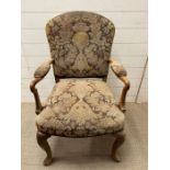 An open arm chair on cabriole legs