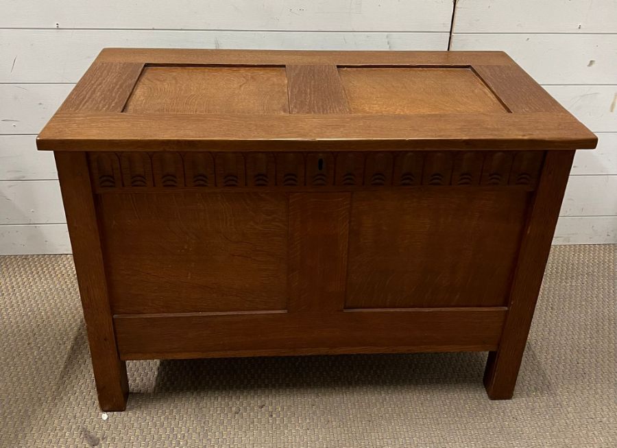 An oak coffer or blanket box with two panels front and lid (H60cm W86cm D44cm)