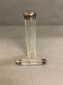 A silver capped scent bottle and a silver capped glass vanity jar.