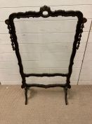 A glass panelled oak fire screen