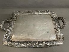 An ornate Japanese silver tray with ornate decorative surround and handles (AF Base needs