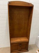 An oak open bookcase with adjustable shelves and cupboard under (H184cm W74cm D27cm)