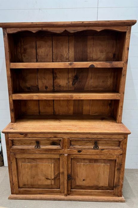 A pine dresser with iron work, Arts and Craft style handles and open plate rack