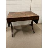 A regency rosewood and cross banded sofa table