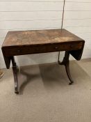 A regency rosewood and cross banded sofa table
