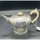 A silver, bullet shaped teapot with engraved design, hallmarked for London 1845 by WR Smily (445g)