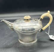 A silver, bullet shaped teapot with engraved design, hallmarked for London 1845 by WR Smily (445g)