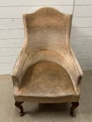 A lounge chair with carved back