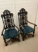 A pair of of Jacobean style arm chairs in oak with cross stretchers and scrolling arms