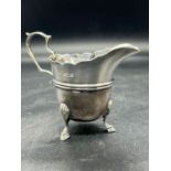 A silver milk jug on four shell and hoof feet, hallmarked for Sheffield 1900 probably by Lee &