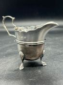 A silver milk jug on four shell and hoof feet, hallmarked for Sheffield 1900 probably by Lee &