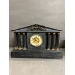 A Victorian black marble mantle clock flanked with five pillars and inlay