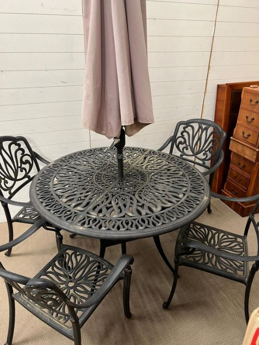 A garden table and chairs with parasol and base