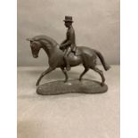 A faux bronze gentleman on a horse