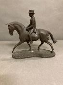 A faux bronze gentleman on a horse