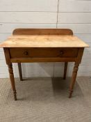 A pine wash stand with drawers to centre (H83cm W84cm D47cm)