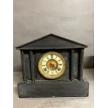 A black slate clock with columns to sides