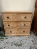 A pine three drawer chest of drawers (H73cm W75cm D42)