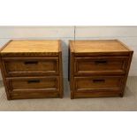 A pair of oak bedsides with two drawers and antiques brass style handles (H60cm W64cm D43cm)