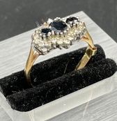 A 9ct sapphire and diamond three stone ring Size M