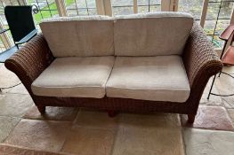 A two seater rattan sofa (H80cm W180cm D88cm)Condition Report no holes to rattan or repairs light