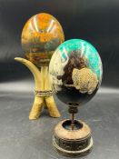 An Africa model egg on stand and Rhino model egg on stand