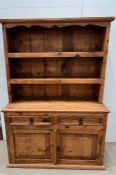 A pine dresser with iron work, Arts and Craft style handles and open plate rack