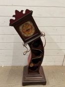 An Alice in Wonderland clock wine rack (H95cm)