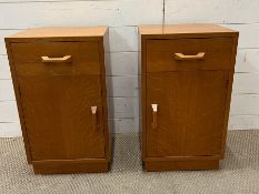 A pair of teak bedside