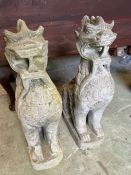 A pair of mythical beast weathered garden statues