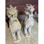 A pair of mythical beast weathered garden statues