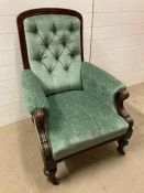 An oak framed button back salon chair with scrolled arms on turned legs (H100cm W70cm D70cm)