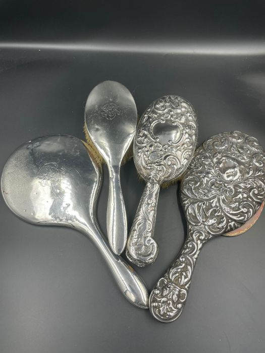 A selection of four silver backed dressing table brushes and mirrors, two of each. (1.155g) - Image 8 of 8