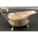 A silver sauce boat on four hoof feet, hallmarked for London 1930, makers mark by H Pidduck &