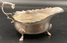 A silver sauce boat on four hoof feet, hallmarked for London 1930, makers mark by H Pidduck &