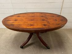 An oval coffee table with lion paw feet (H55cm W120cm D77cm)