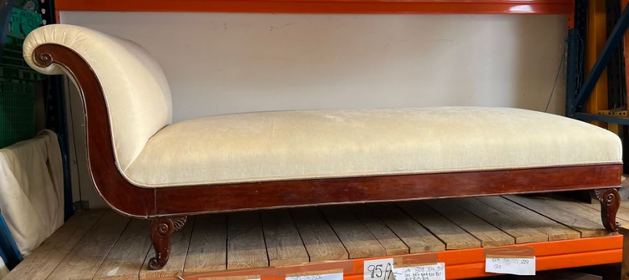 A George IV style mahogany chaise lounge, re-upholstered with padded back and scrolled ends,
