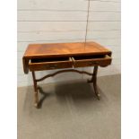 A sofa table with drop ends, drawers to centre on out swept legs (H66cm W58cm D42cm)