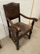 An oak open armchair on turned front legs