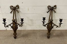 A pair of brass figurative wall sconces.